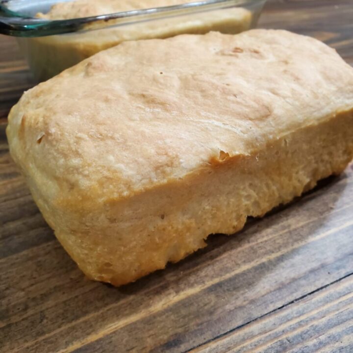 Fresh crusty bread from the oven sitting on the table to cool.