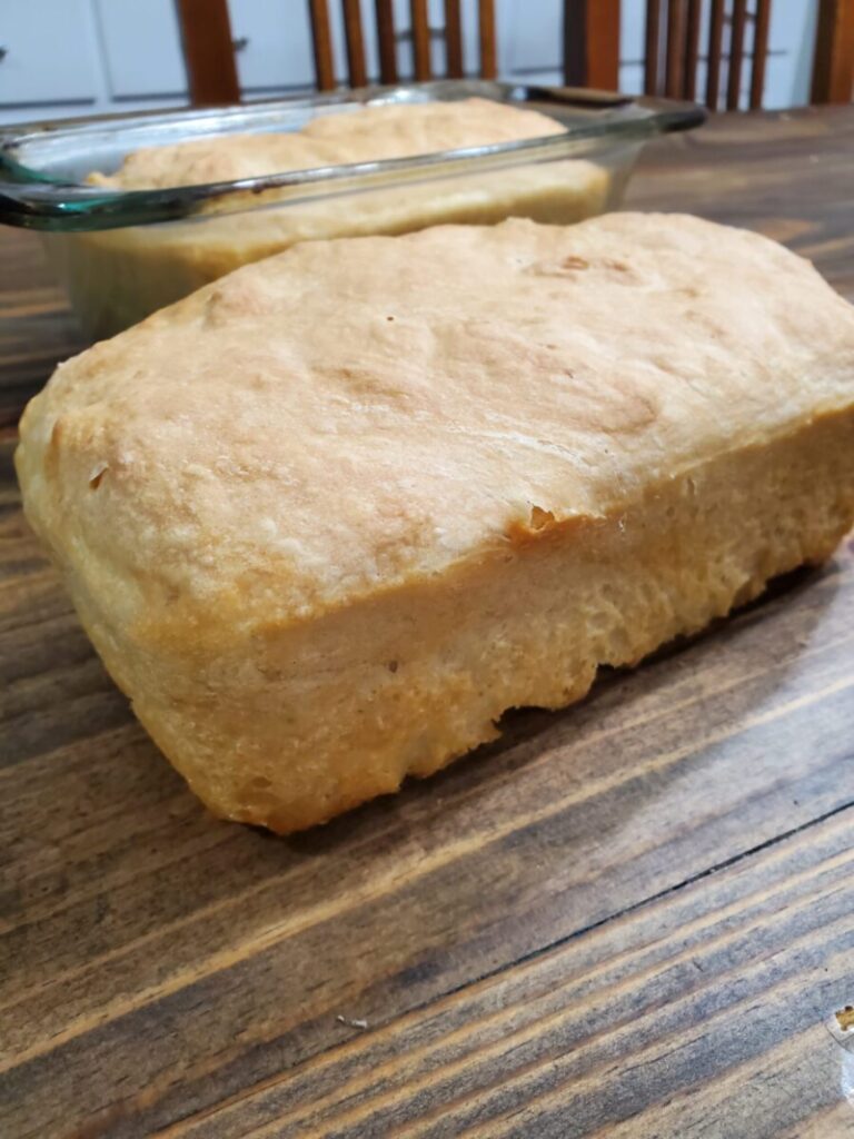 Fresh crusty bread from the oven sitting on the table to cool.